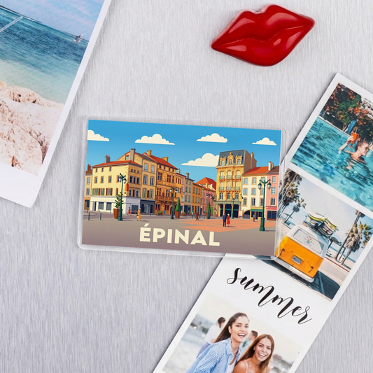 Magnet souvenir de la ville de Épinal avec une illustration stylisée de ses bâtiments colorés.