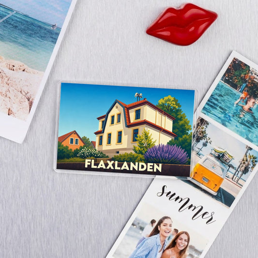 Magnet souvenir de la ville de Flaxlanden avec une illustration stylisée d'une maison alsacienne.