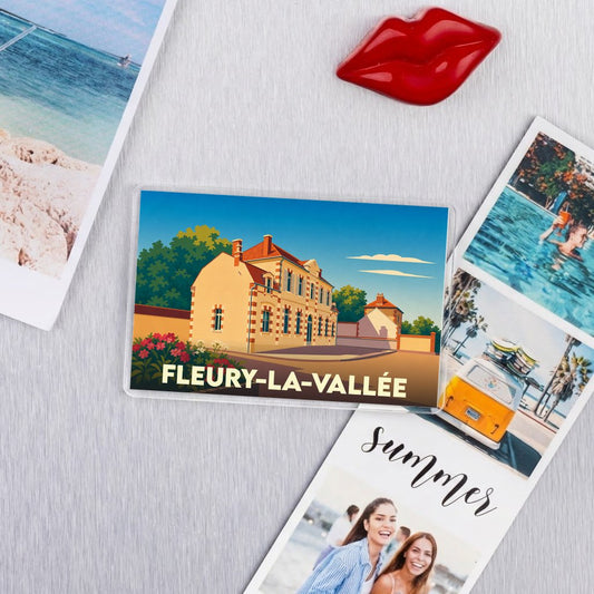 Magnet souvenir de la ville de Fleury-la-Vallée avec une illustration stylisée d'un bâtiment traditionnel.