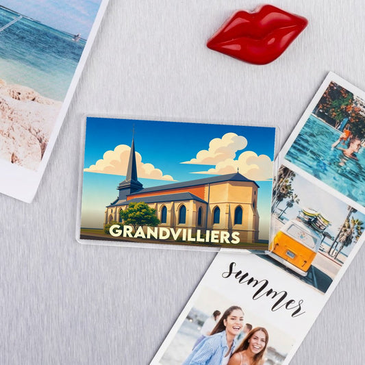 Magnet souvenir de la ville de Grandvilliers avec une illustration stylisée de son église.