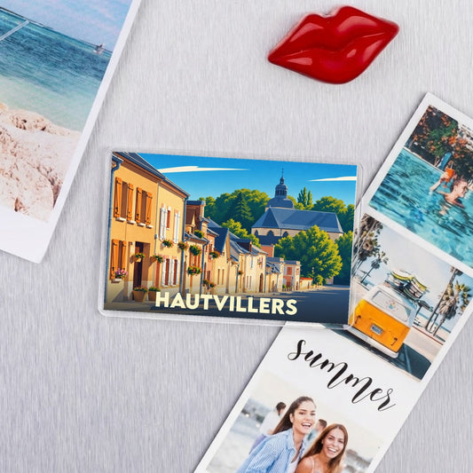 Magnet souvenir de la ville de Hautvillers avec une illustration colorée de ses rues et de son église.