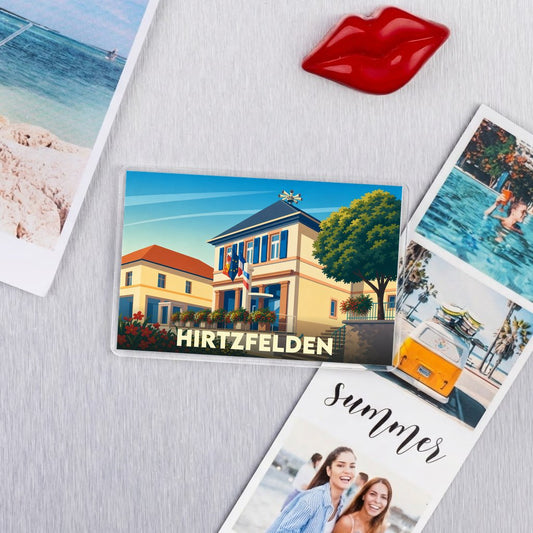 Magnet souvenir de la ville de Hirtzfelden avec une illustration stylisée.