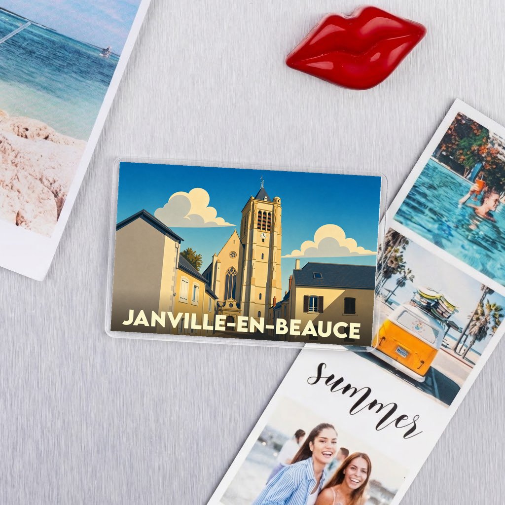 Magnet souvenir de Janville-en-Beauce avec une illustration stylisée de son église et de ses maisons sous un ciel d'été.