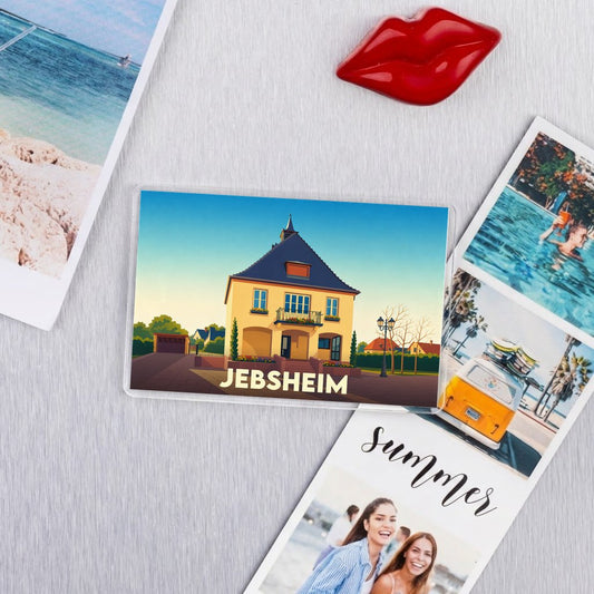 Magnet souvenir de la ville de Jebsheim avec une illustration stylisée d'une maison alsacienne.