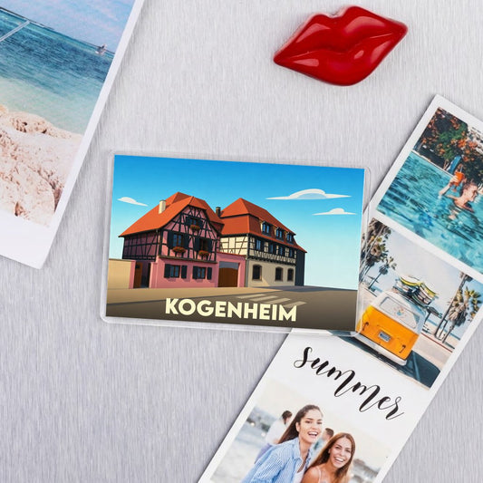 Magnet souvenir de la ville de Kogenheim avec une illustration stylisée de maisons à colombages.