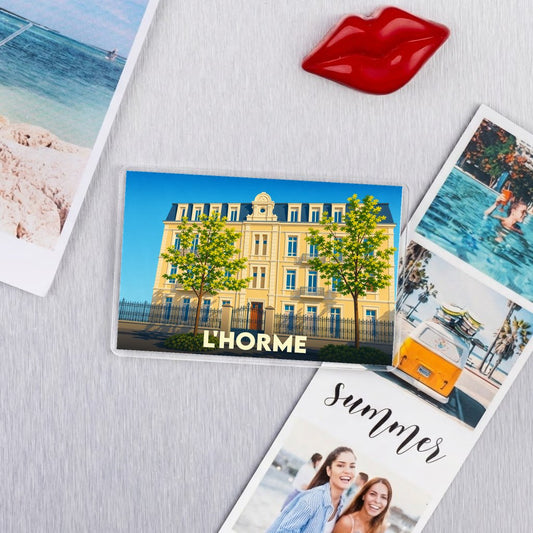 Magnet souvenir de la ville de L'Horme avec une illustration stylisée.