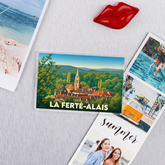 Magnet souvenir de la ville de La Ferté-Alais avec une illustration stylisée d'un village niché dans la verdure.