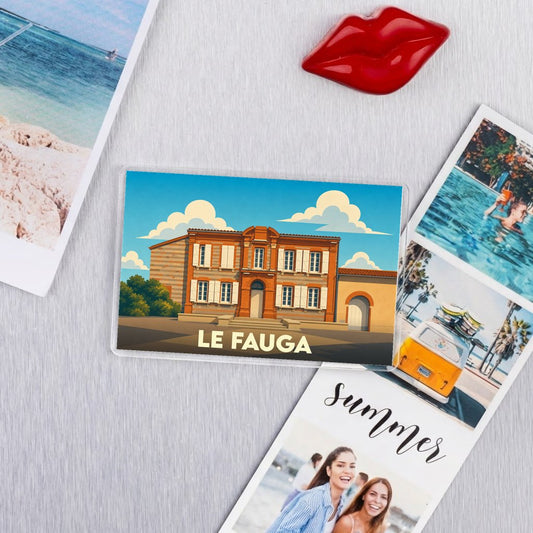 Magnet souvenir de la ville de Le Fauga avec une illustration stylisée d'un bâtiment typique.