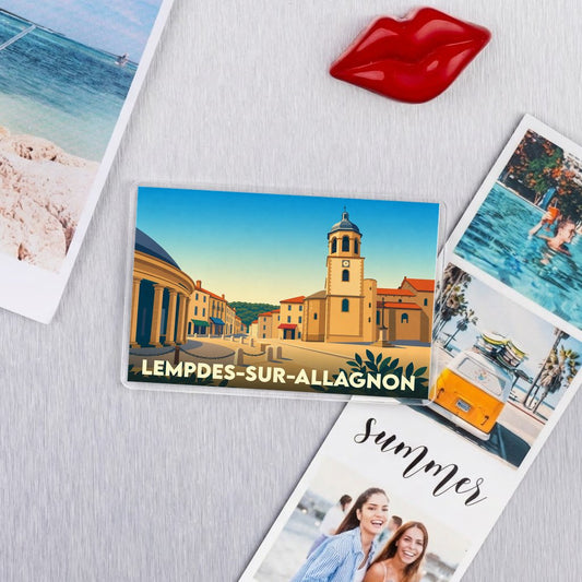 Magnet souvenir de la ville de Lempdes-sur-Allagnon avec une illustration stylisée de son église et ses bâtiments.