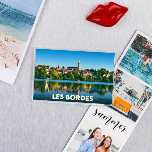 Aimant de réfrigérateur souvenir de la ville de Les Bordes illustrant un paysage urbain au bord de l'eau.