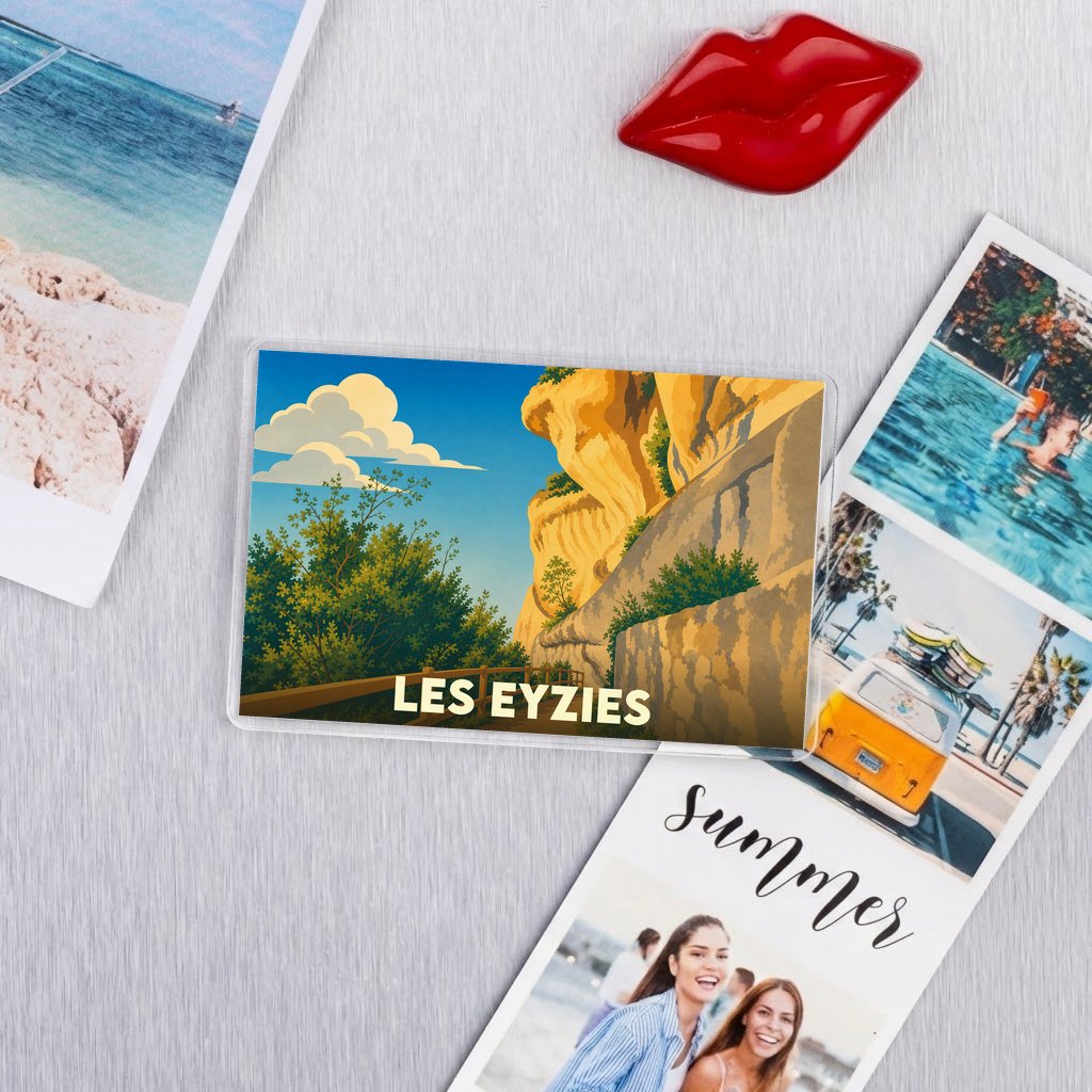 Magnet souvenir de la ville de Les Eyzies avec une illustration stylisée de ses falaises.