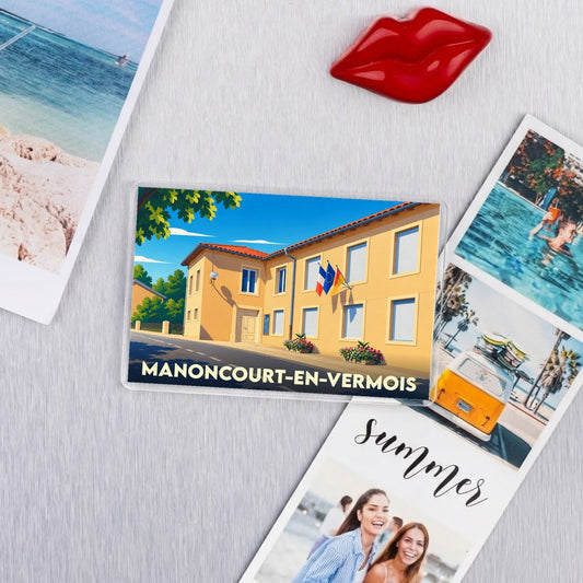 Magnet souvenir de la ville de Manoncourt-en-Vermois avec une illustration stylisée de la mairie.