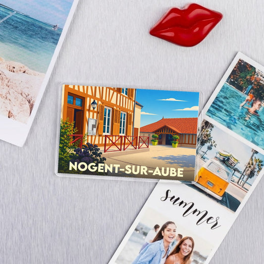 Magnet souvenir de la ville de Nogent-sur-Aube avec une illustration stylisée d'un bâtiment à colombages.