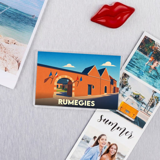 Magnet souvenir de la ville de Rumegies avec une illustration stylisée d'un bâtiment typique.