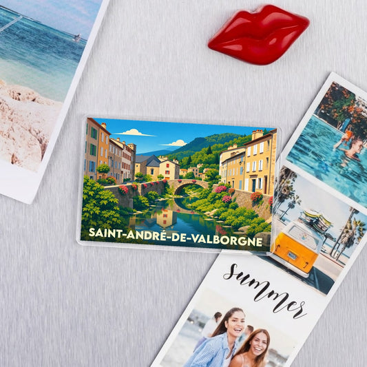 Magnet souvenir de la ville de Saint-André-de-Valborgne avec une illustration stylisée d'un pont et d'une rivière.