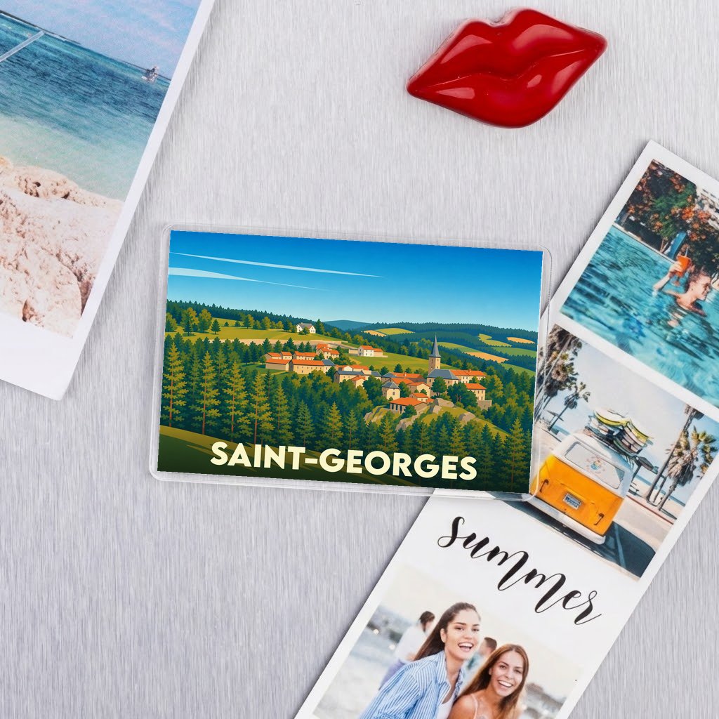 Magnet souvenir de la ville de Saint-Georges avec une illustration stylisée d'un village de montagne.