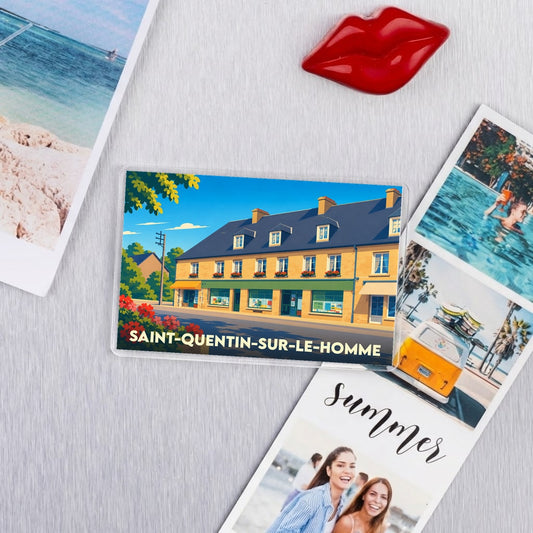 Magnet souvenir de la ville de Saint-Quentin-sur-le-Homme avec une illustration colorée et stylisée.