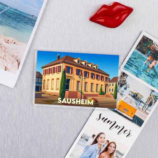 Magnet souvenir de la ville de Sausheim avec une illustration stylisée.