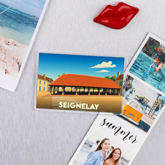 Magnet souvenir de la ville de Seignelay avec une illustration stylisée de ses halles historiques.