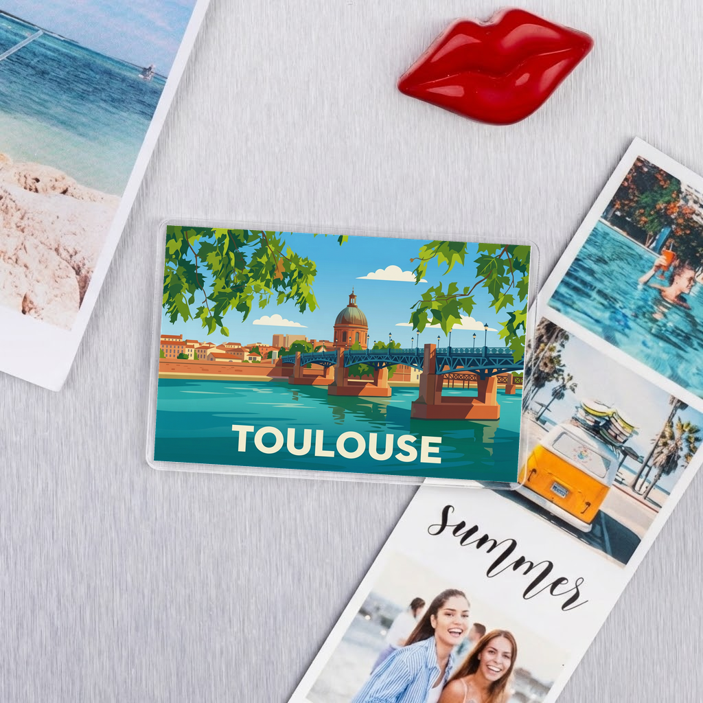 Magnet souvenir de la ville de Toulouse avec une illustration stylisée du dôme de la Grave et du pont Saint-Pierre.