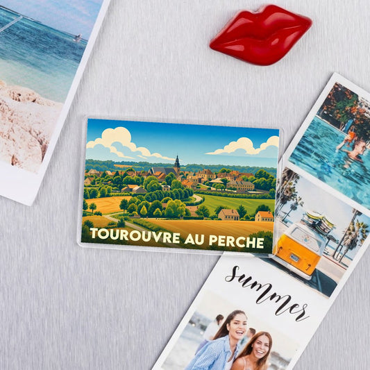 Magnet souvenir de la ville de Tourouvre au Perche avec une illustration de paysage champêtre.