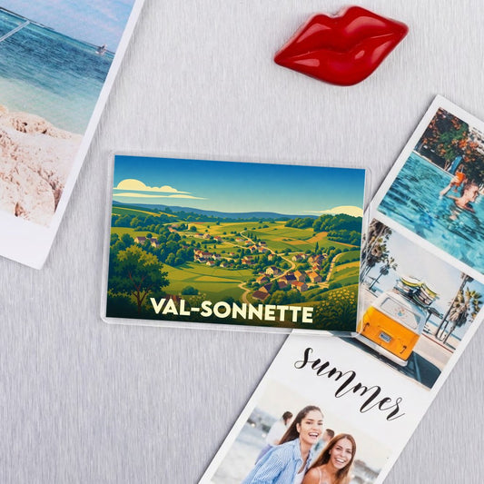 Magnet souvenir de la ville de Val-Sonnette avec une illustration de paysages vallonnés.