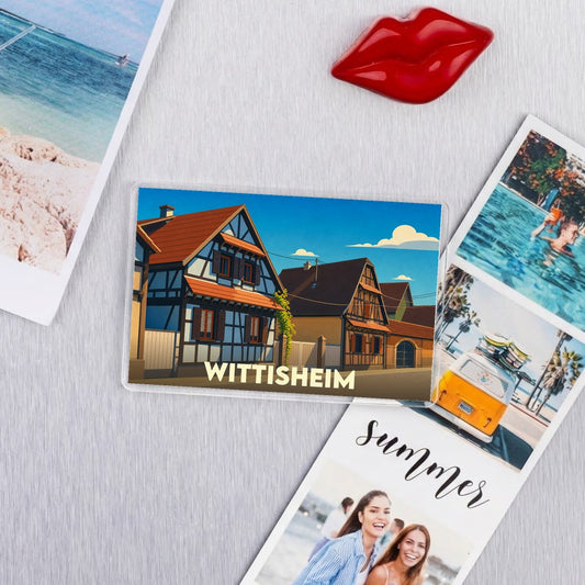 Magnet souvenir de la ville de Wittisheim avec une illustration stylisée de maisons à colombages.