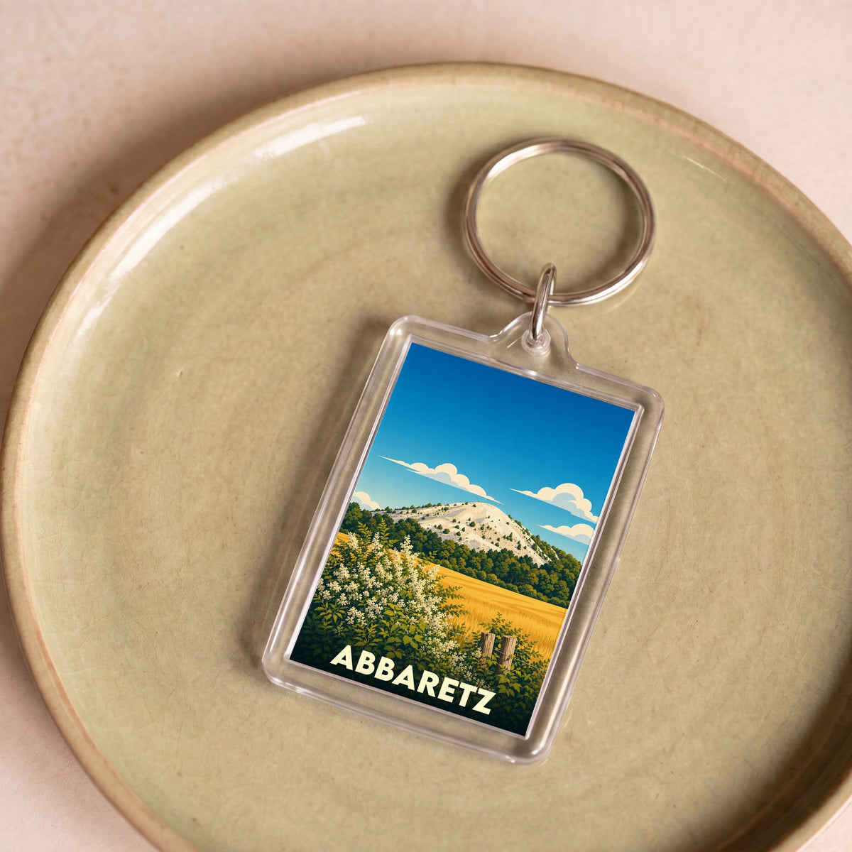 Porte-clés souvenir de la ville d'Abbaretz avec une illustration stylisée de son terril.