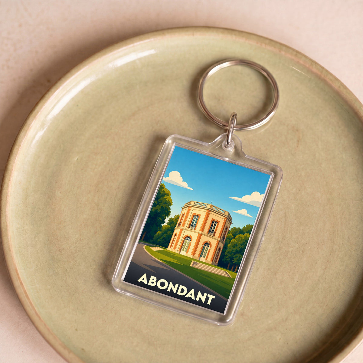 Porte-clés souvenir de la ville d'Abondant avec une illustration stylisée de son château.