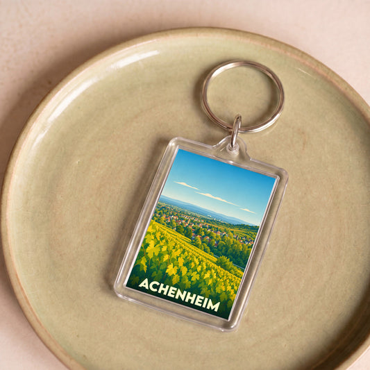 Porte-clés souvenir de la ville d'Achenheim avec une illustration stylisée de vignobles.