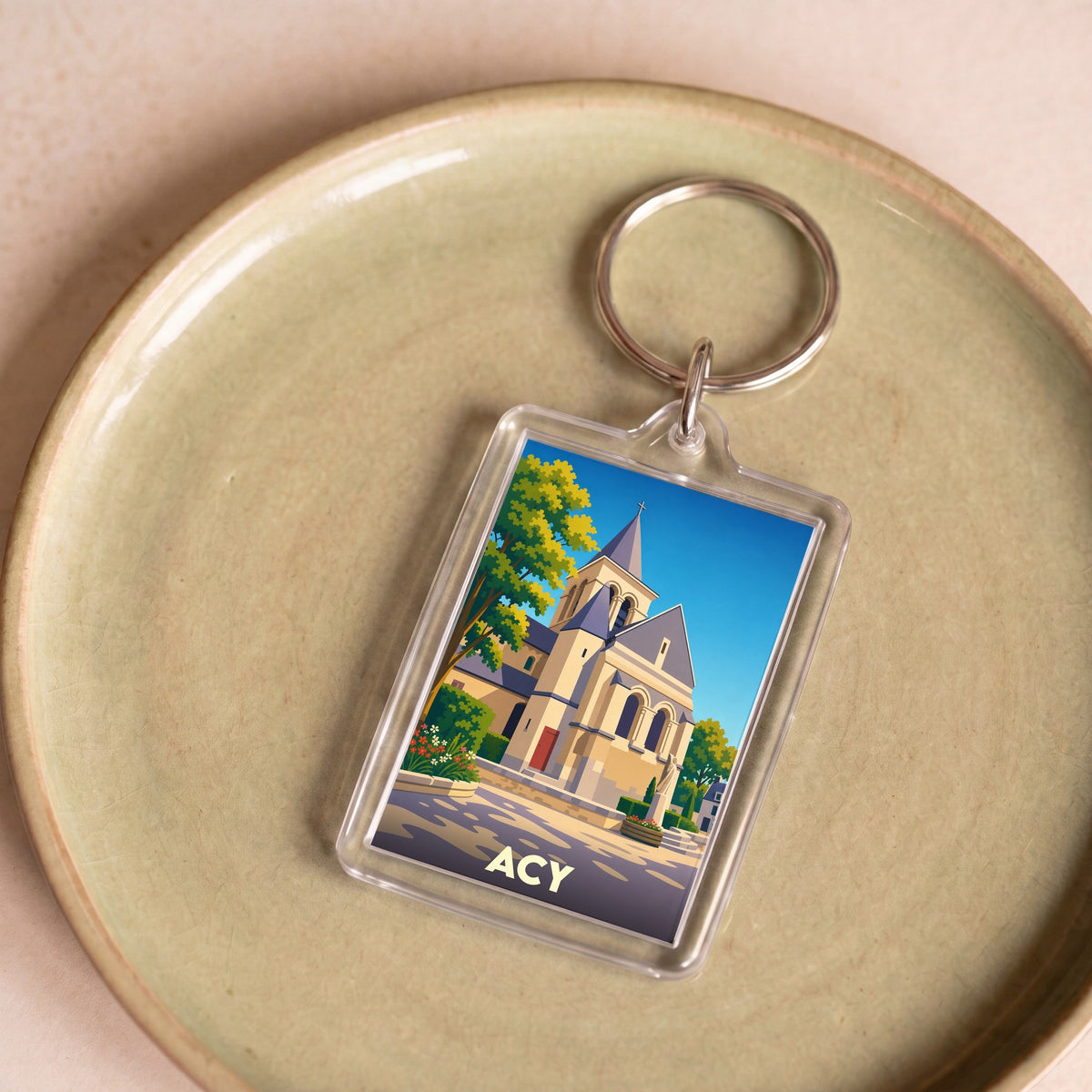 Porte-clés souvenir de la ville d'Acy avec une illustration stylisée de son église.
