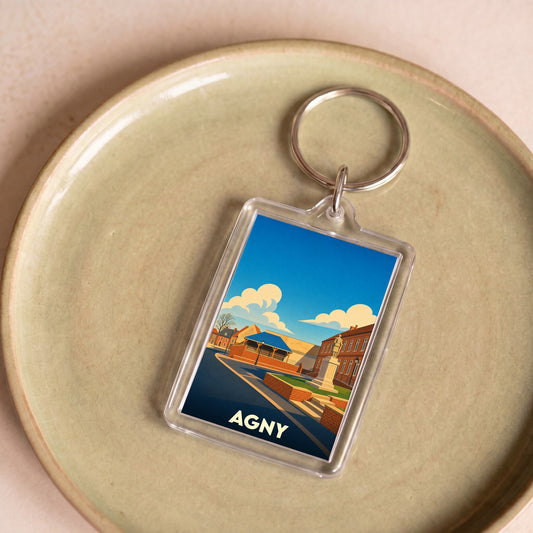 Porte-clés souvenir de la ville d'Agny avec une illustration stylisée.