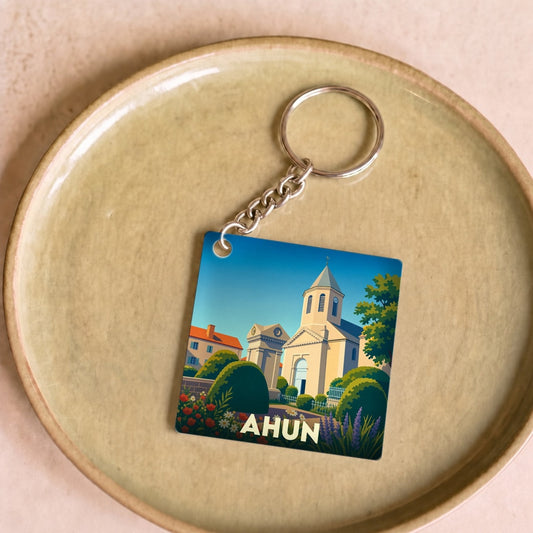 Porte-clés souvenir de la ville de Ahun avec une illustration colorée et stylisée de son église.