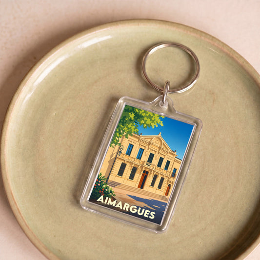 Porte-clés souvenir de la ville d'Aimargues avec une illustration stylisée de son hôtel de ville.
