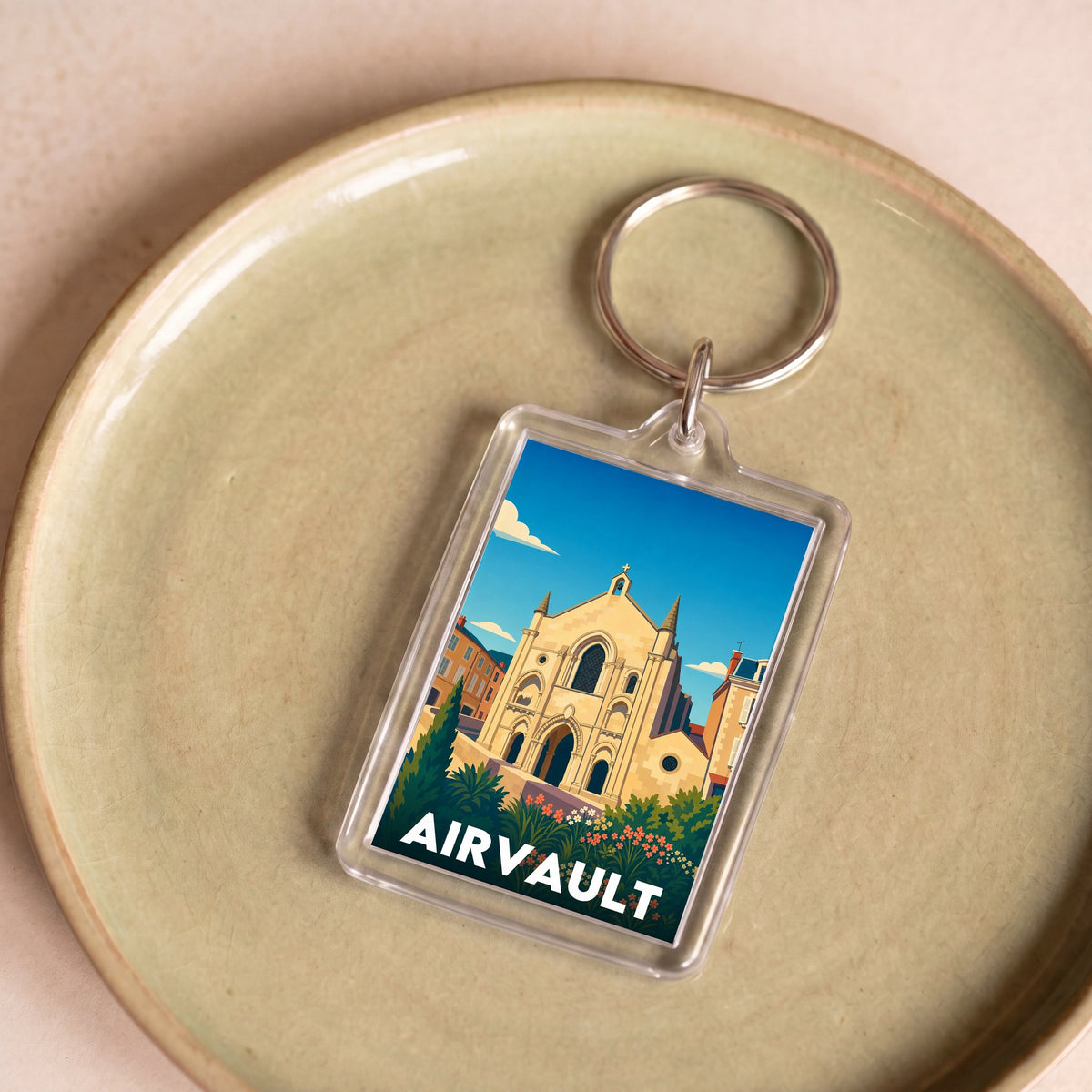 Porte-clés souvenir de la ville d'Airvault avec une illustration stylisée de son patrimoine.