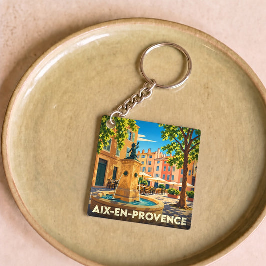 Porte-clés souvenir de la ville de Aix-en-Provence avec une illustration stylisée de sa célèbre fontaine.