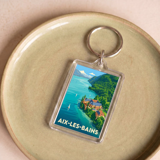 Porte-clés souvenir de la ville d'Aix-les-Bains avec une illustration stylisée de son paysage lacustre.