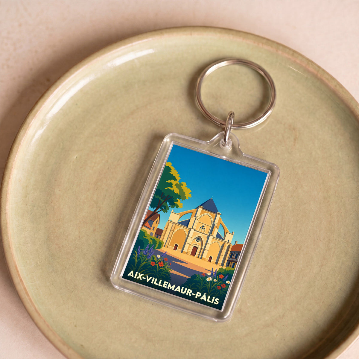 Porte-clés souvenir de la ville de Aix-Villemaur-Pâlis avec une illustration stylisée.