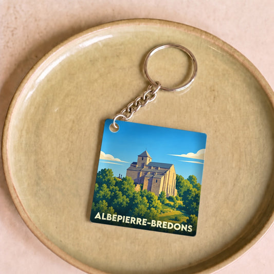 Porte-clés souvenir de la ville de Albepierre-Bredons avec une illustration stylisée de son église.