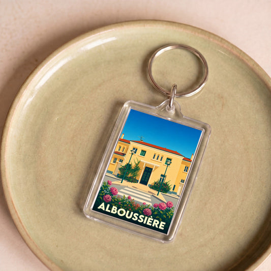 Porte-clés souvenir de la ville d'Alboussière avec une illustration stylisée.
