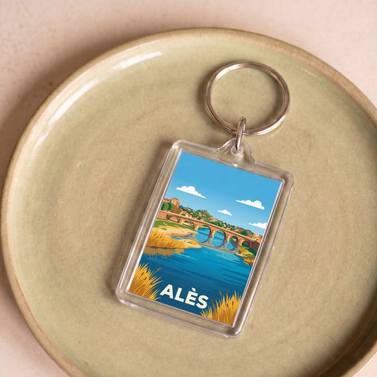 Porte-clés souvenir de la ville d'Alès avec une illustration stylisée.