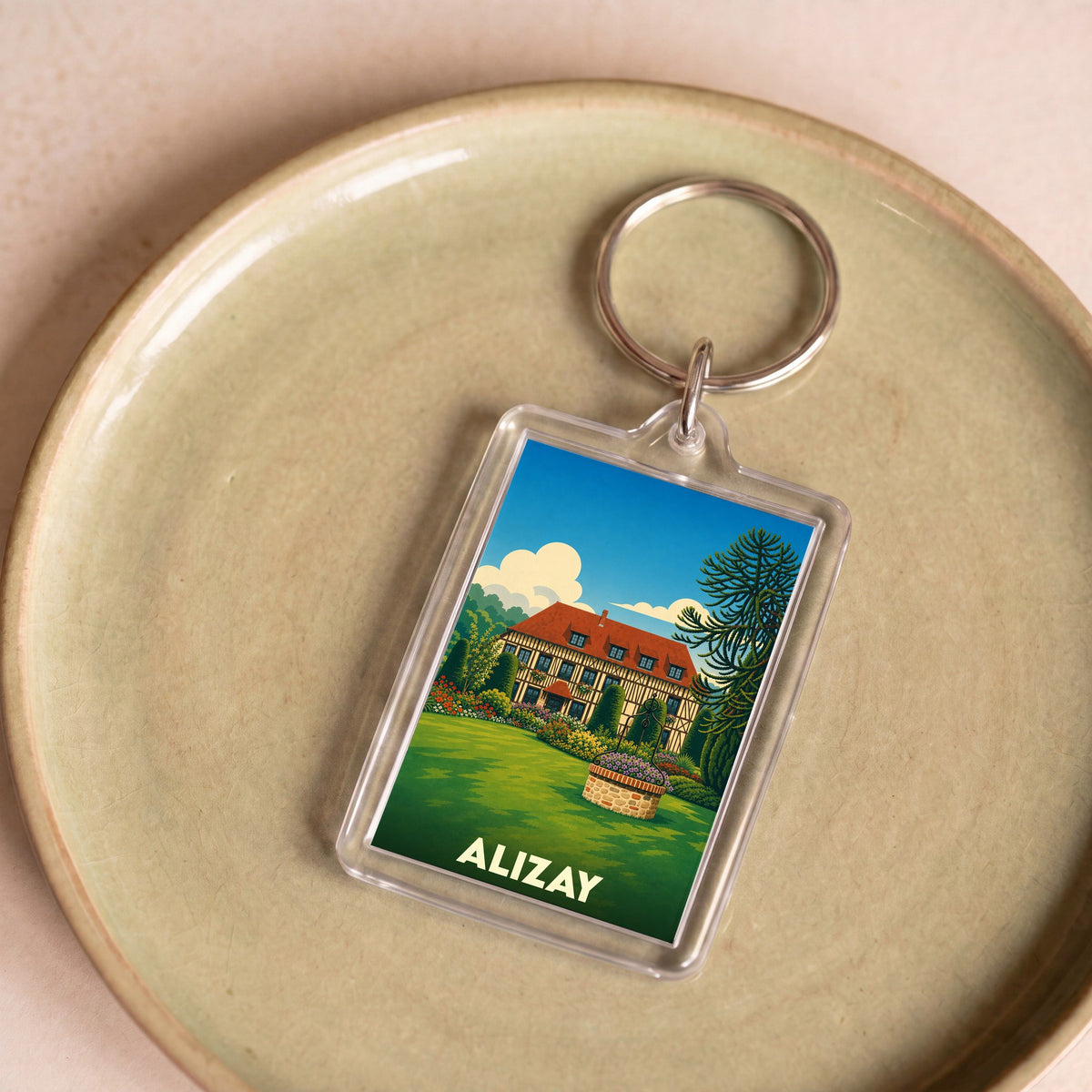 Porte-clés souvenir de la ville d'Alizay avec une illustration stylisée.