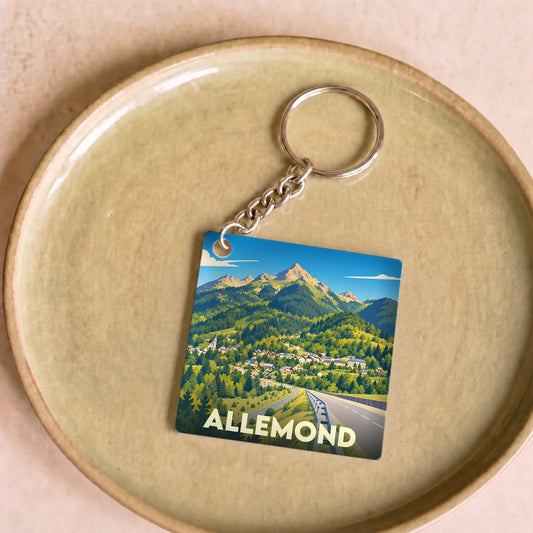 Porte-clés souvenir de la ville d'Allemond orné d'une illustration de paysage montagnard.