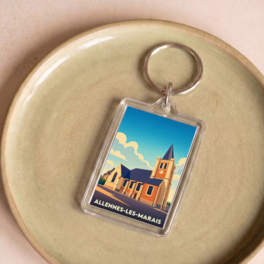 Porte-clés souvenir de la ville d'Allennes-les-Marais avec une illustration stylisée de son église.