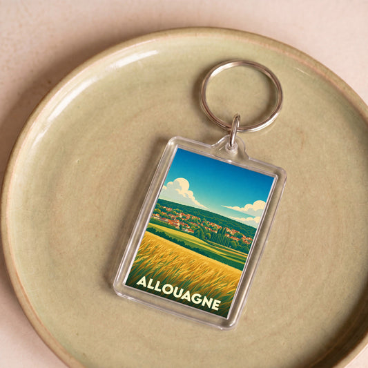 Porte-clés souvenir de la ville d'Allouagne avec une illustration stylisée de paysages champêtres.