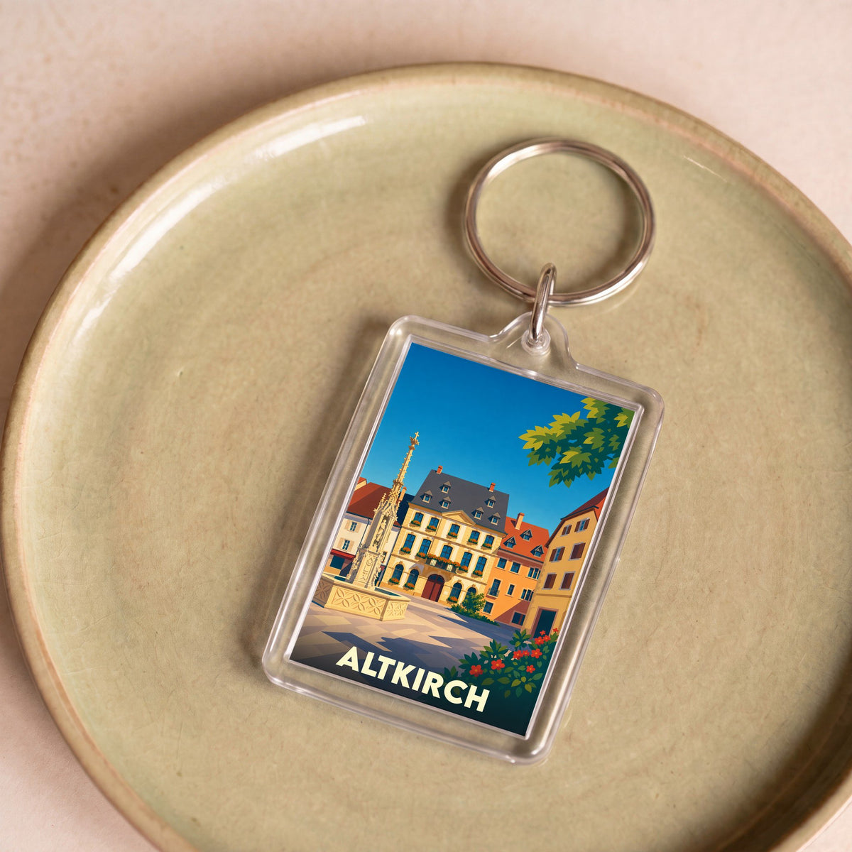 Porte-clés souvenir de la ville d'Altkirch avec une illustration stylisée et colorée de sa place historique.