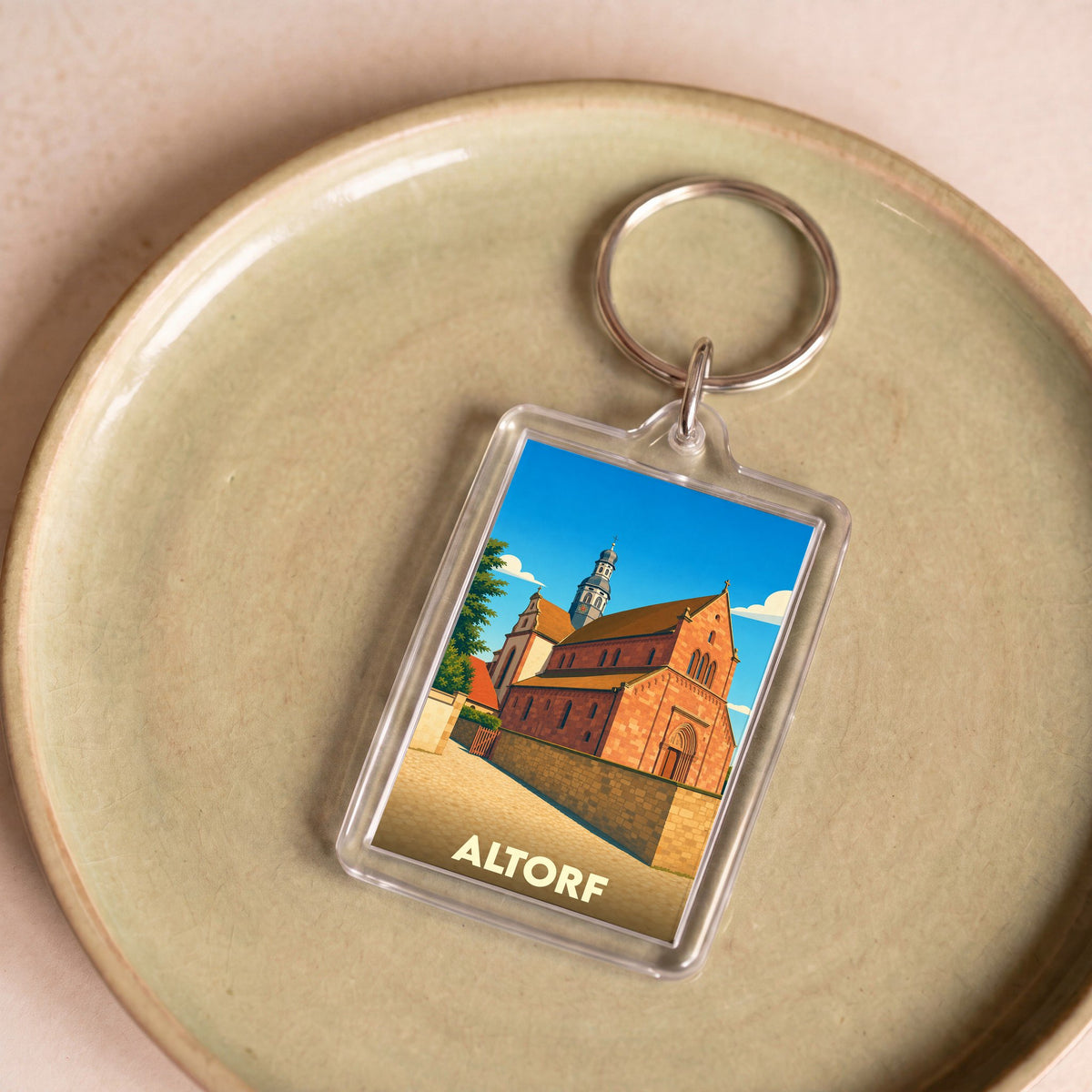 Porte-clés souvenir de la ville de Altorf avec une illustration stylisée de son église.
