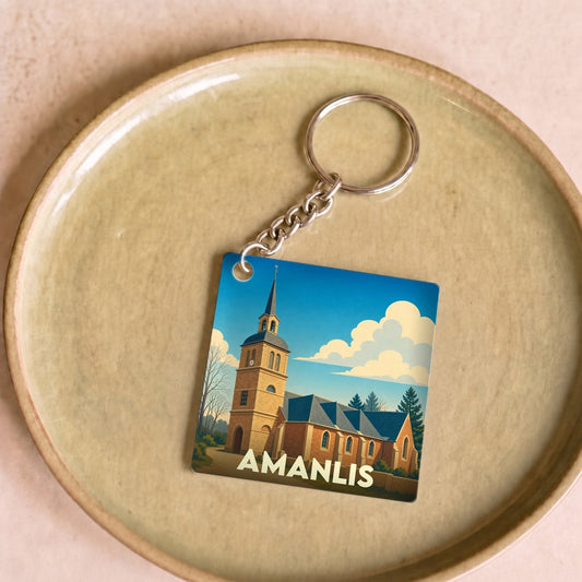 Porte-clés souvenir de la ville d'Amanlis avec une illustration stylisée de son église.