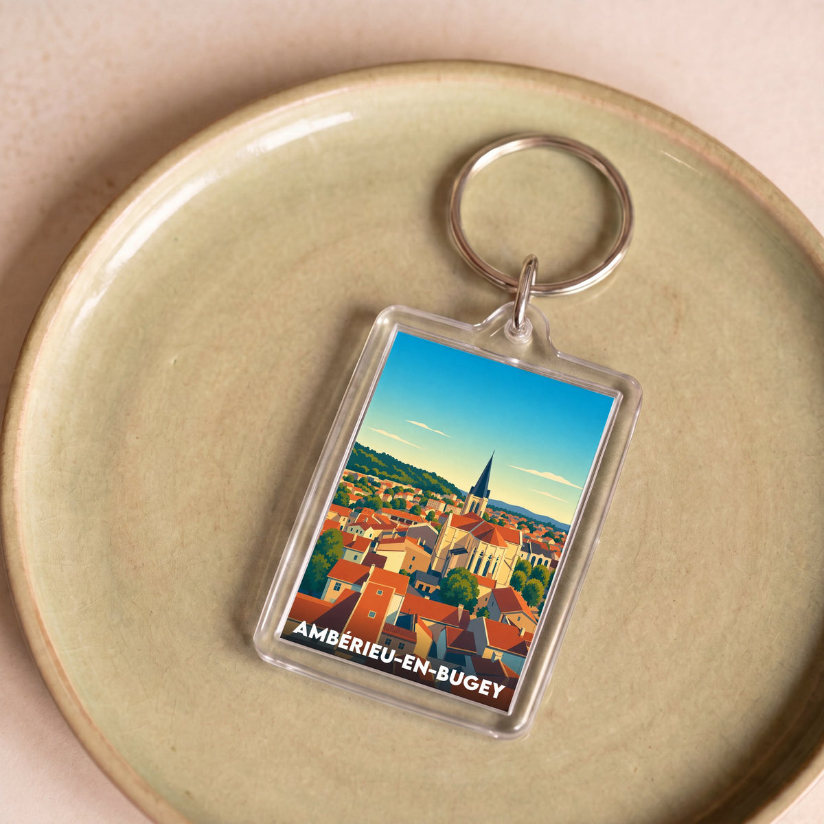 Porte-clés souvenir de la ville d'Ambérieu-en-Bugey avec une illustration stylisée.