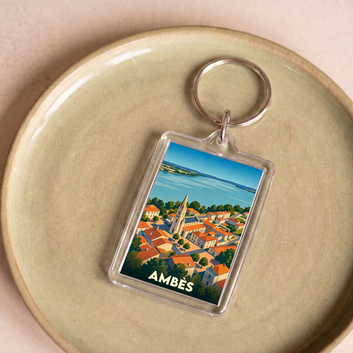Porte-clés souvenir de la ville d'Ambès avec une illustration stylisée.